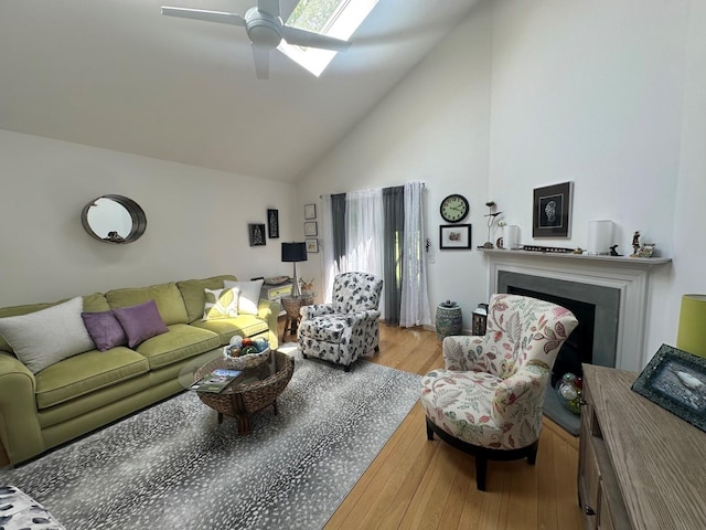 60 Skyline Dr, Keene, NH 03431 - living area with high vaulted ceiling, wood finished floors, a skylight, a fireplace, and ceiling fan