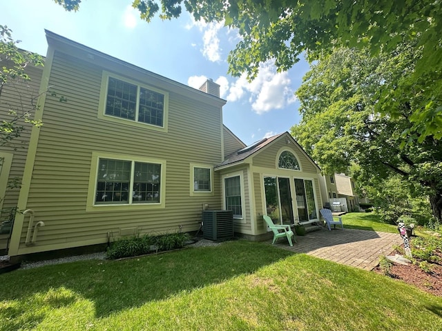 60 Skyline Dr, Keene, NH 03431 - rear view of house featuring central AC, a patio area, a chimney, and a yard