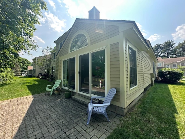 60 Skyline Dr, Keene, NH 03431 - rear view of property featuring a patio area, a lawn, and a chimney