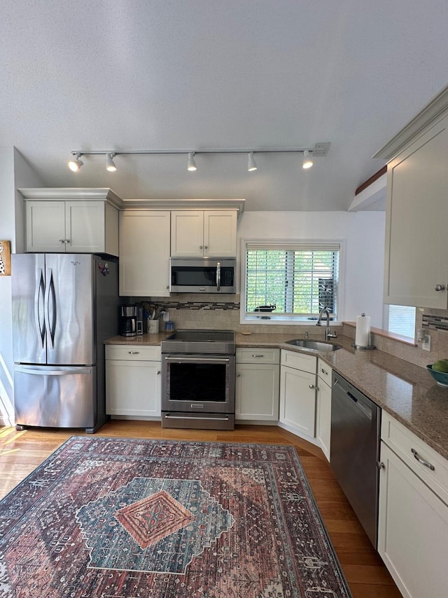 60 Skyline Dr, Keene, NH 03431 - kitchen with stainless steel appliances, a sink, light wood-type flooring, and track lighting