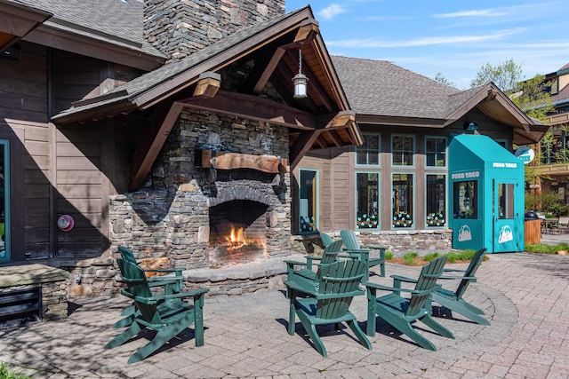 69 Hourglass Dr Unit 205, Stowe, VT 05672 - view of patio / terrace with an outdoor stone fireplace