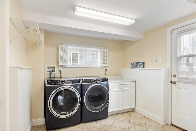 30 Ancient Hwy, Hampton, NH 03842 - laundry area with separate washer and dryer, healthy amount of natural light, light tile patterned floors, cabinet space, and a wainscoted wall
