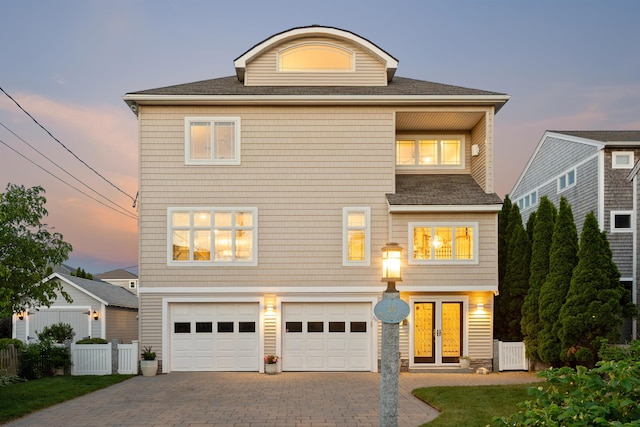 30 Ancient Hwy, Hampton, NH 03842 - view of front facade featuring an attached garage, driveway, french doors, and a shingled roof