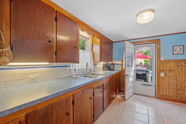 57 Lakeside Rd, Bristol, NH 03222 - kitchen featuring a sink, tasteful backsplash, plenty of natural light, wooden walls, and brown cabinets