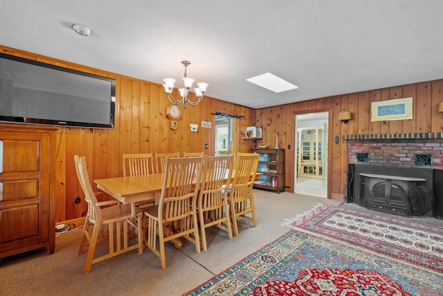 57 Lakeside Rd, Bristol, NH 03222 - dining space with carpet floors, a chandelier, a skylight, and wood walls