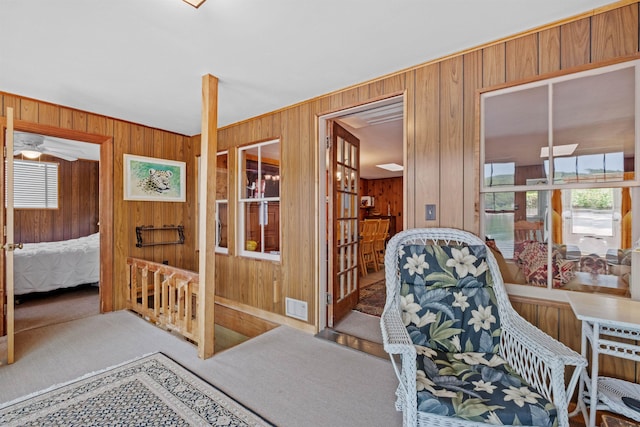 57 Lakeside Rd, Bristol, NH 03222 - sitting room featuring carpet flooring, wood walls, and ceiling fan