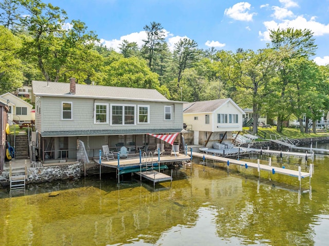 57 Lakeside Rd, Bristol, NH 03222 - rear view of house featuring boat lift, a water view, a chimney, and stairs