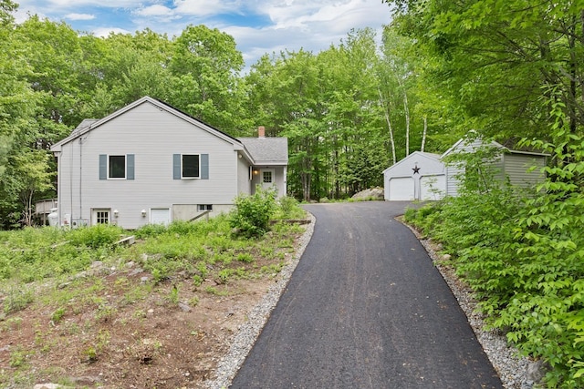 161 Frank C Gilman Hwy, Alton, NH 03809 - view of side of property with an outbuilding, a chimney, and a detached garage