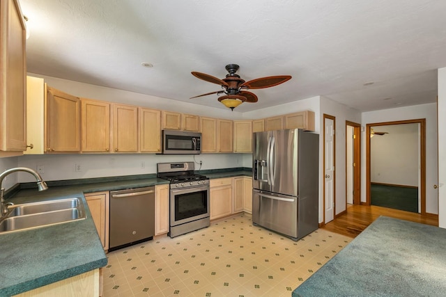 161 Frank C Gilman Hwy, Alton, NH 03809 - kitchen with appliances with stainless steel finishes, a sink, light brown cabinets, and ceiling fan