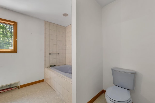 161 Frank C Gilman Hwy, Alton, NH 03809 - bathroom with toilet, tiled tub, and baseboards
