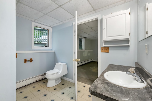 161 Frank C Gilman Hwy, Alton, NH 03809 - bathroom with a baseboard heating unit, a baseboard radiator, a paneled ceiling, toilet, and vanity