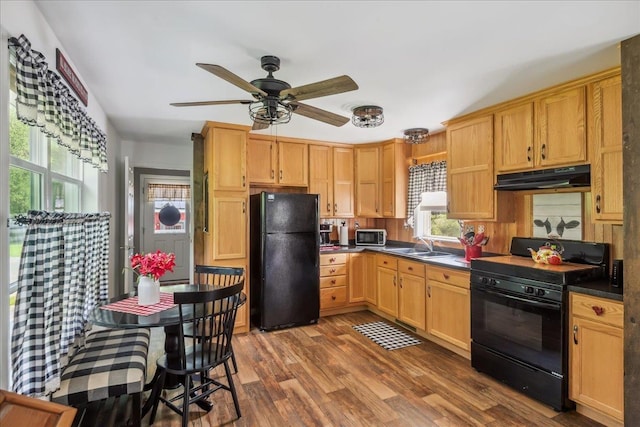 4611 W Berkshire Rd, Enosburg, VT 05450 - kitchen featuring black appliances, under cabinet range hood, a ceiling fan, wood finished floors, and dark countertops