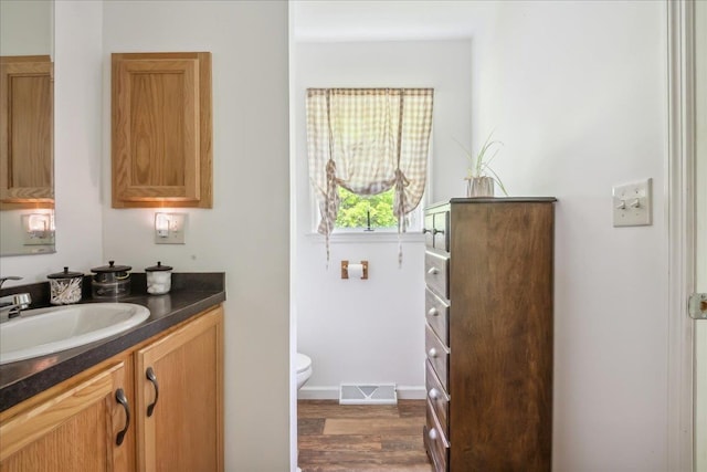 4611 W Berkshire Rd, Enosburg, VT 05450 - bathroom featuring vanity, toilet, wood finished floors, and baseboards