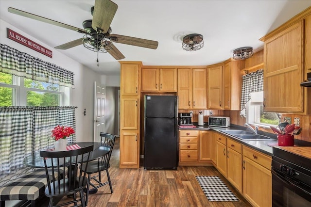4611 W Berkshire Rd, Enosburg, VT 05450 - kitchen with freestanding refrigerator, stove, dark wood-style floors, a sink, and plenty of natural light