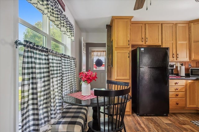 4611 W Berkshire Rd, Enosburg, VT 05450 - kitchen featuring freestanding refrigerator, dark wood-style flooring, dark countertops, stainless steel microwave, and a ceiling fan