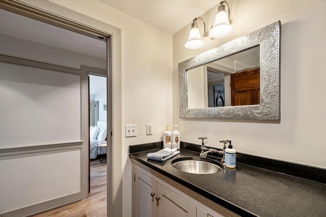 4780 Mountain Rd, Stowe, VT 05672 - ensuite bathroom with vanity and wood finished floors