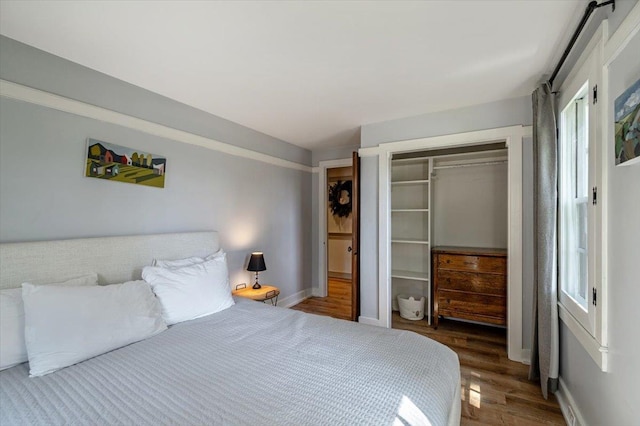 4780 Mountain Rd, Stowe, VT 05672 - bedroom featuring wood finished floors, a closet, baseboards, and multiple windows