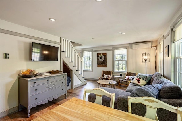 4780 Mountain Rd, Stowe, VT 05672 - living area with a wall mounted AC, stairway, light wood-style flooring, recessed lighting, and baseboards