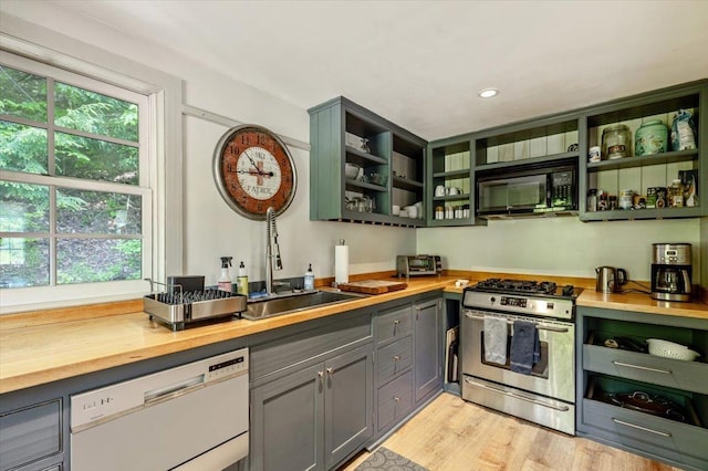 4780 Mountain Rd, Stowe, VT 05672 - kitchen with stainless steel range with gas stovetop, dishwasher, black microwave, butcher block counters, and open shelves