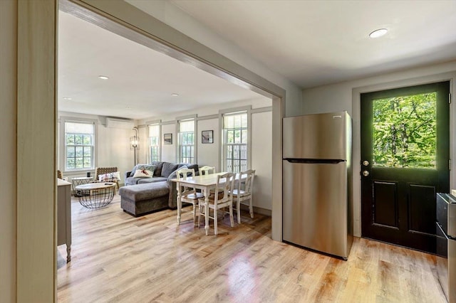 4780 Mountain Rd, Stowe, VT 05672 - kitchen with freestanding refrigerator, light wood-style floors, an AC wall unit, and open floor plan