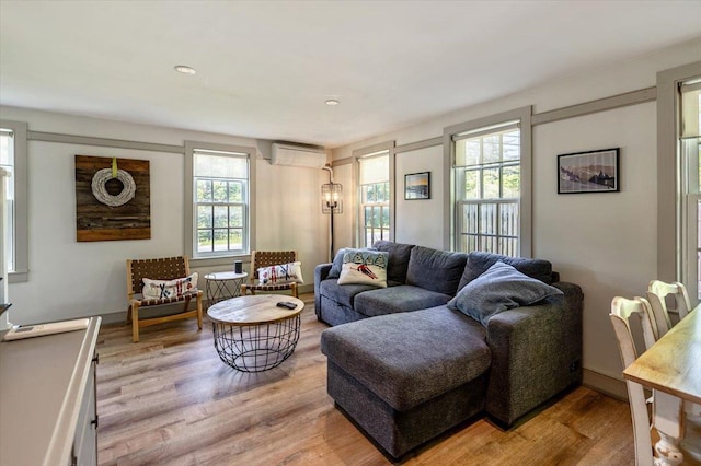 4780 Mountain Rd, Stowe, VT 05672 - living area featuring an AC wall unit and light wood-type flooring