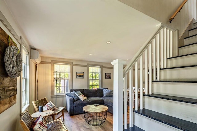 4780 Mountain Rd, Stowe, VT 05672 - living room featuring wood finished floors, stairway, an AC wall unit, and recessed lighting