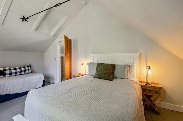 4780 Mountain Rd, Stowe, VT 05672 - bedroom with vaulted ceiling, attic access, wood finished floors, and baseboards
