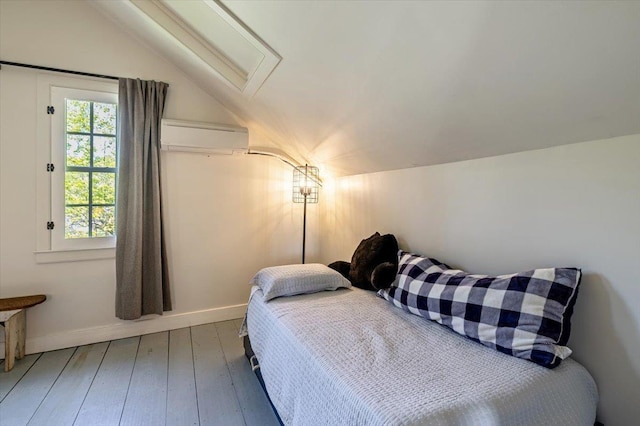 4780 Mountain Rd, Stowe, VT 05672 - bedroom with a wall mounted air conditioner, lofted ceiling, hardwood / wood-style flooring, baseboards, and attic access