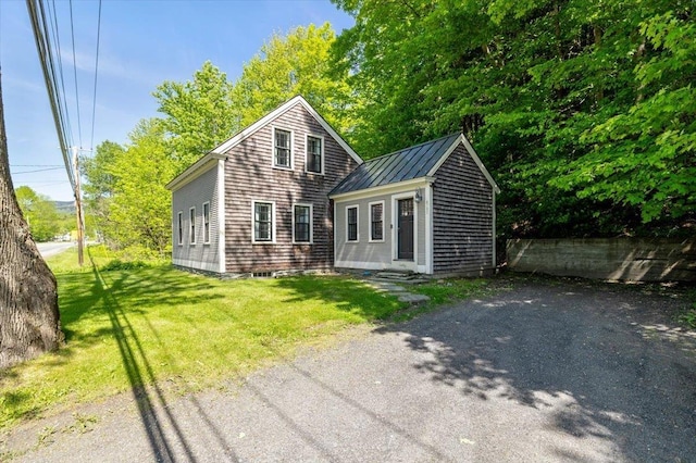 4780 Mountain Rd, Stowe, VT 05672 - view of front facade with a standing seam roof, a front yard, and metal roof