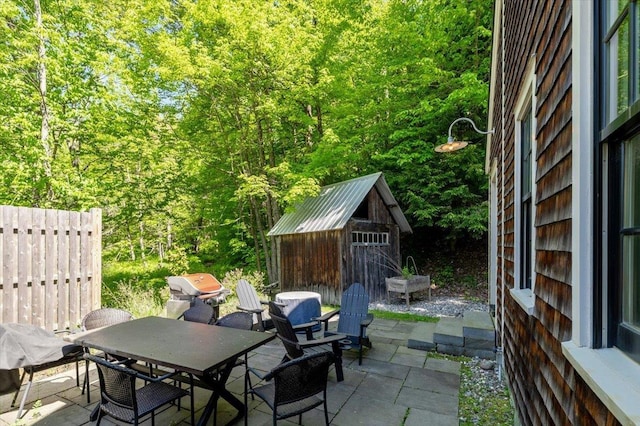 4780 Mountain Rd, Stowe, VT 05672 - view of patio / terrace with outdoor dining space, a grill, and a wooded view