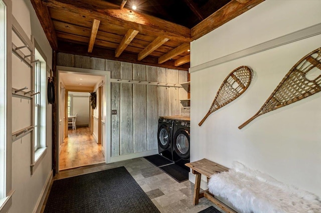 4780 Mountain Rd, Stowe, VT 05672 - foyer entrance featuring washer and clothes dryer, wooden ceiling with exposed beams, wood walls, baseboards, and tile patterned floors