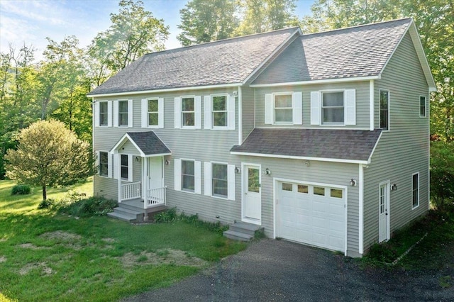 165 Golf Course Rd, Warren, VT 05674 - colonial house featuring a garage, a shingled roof, driveway, and a front lawn