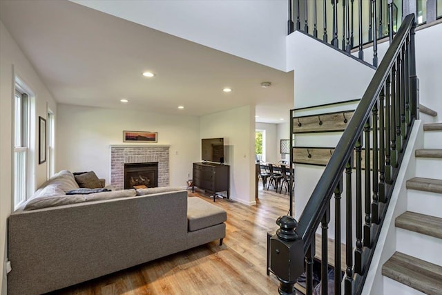 165 Golf Course Rd, Warren, VT 05674 - living area with light wood-type flooring, recessed lighting, stairs, a fireplace, and baseboards