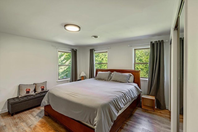 165 Golf Course Rd, Warren, VT 05674 - bedroom with multiple windows and wood finished floors