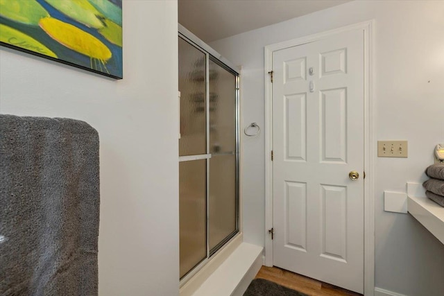 165 Golf Course Rd, Warren, VT 05674 - bathroom featuring a shower with shower door and wood finished floors