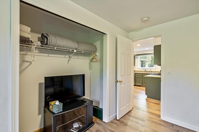 165 Golf Course Rd, Warren, VT 05674 - bedroom with light wood-style flooring, baseboards, and a sink