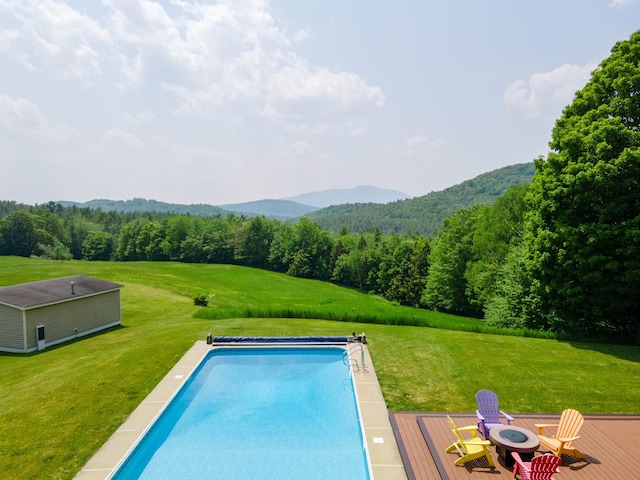 402 E Rd, Cornish, NH 03745 - view of swimming pool featuring an outdoor fire pit, a covered pool, a view of trees, and a lawn