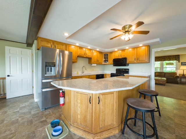 402 E Rd, Cornish, NH 03745 - kitchen featuring black appliances, a sink, a kitchen island, recessed lighting, and light stone countertops