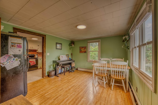 336 N Rd, Lancaster, NH 03584 - dining space featuring ornamental molding, baseboard heating, light wood finished floors, and a baseboard radiator