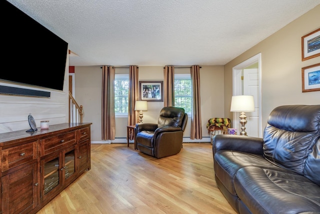 50 Kienia Rd, Hudson, NH 03051 - living room featuring baseboard heating, light wood finished floors, and a textured ceiling