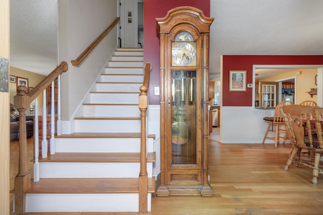 50 Kienia Rd, Hudson, NH 03051 - stairs with a textured ceiling and wood finished floors