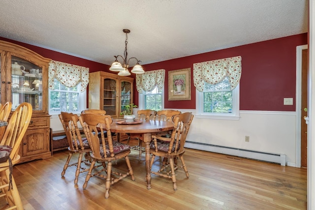 50 Kienia Rd, Hudson, NH 03051 - dining room with baseboard heating, a chandelier, light wood-type flooring, and a textured ceiling
