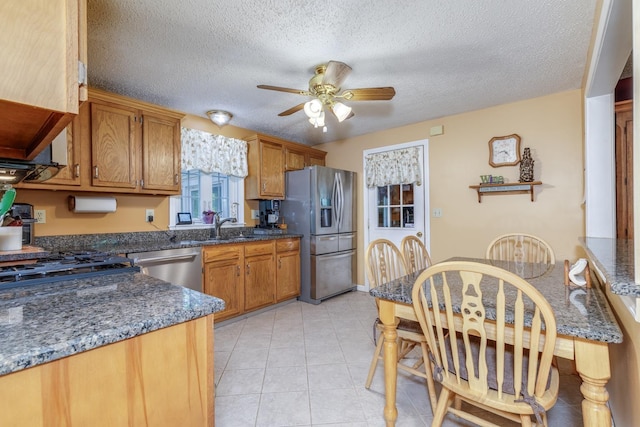 50 Kienia Rd, Hudson, NH 03051 - kitchen with stainless steel appliances, a ceiling fan, brown cabinets, a textured ceiling, and a sink