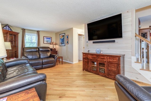 50 Kienia Rd, Hudson, NH 03051 - living room with a textured ceiling, light wood-type flooring, stairway, and baseboards