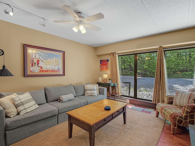 137 E Mountain Rd Unit 2A3, Killington, VT 05751 - living room featuring ceiling fan, wood finished floors, baseboard heating, and a textured ceiling