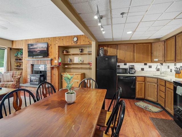 137 E Mountain Rd Unit 2A3, Killington, VT 05751 - kitchen featuring black appliances, a sink, wood finished floors, tasteful backsplash, and wooden walls