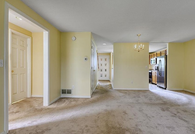 1 Wesley Ln, Keene, NH 03431 - empty room with a chandelier, light colored carpet, and baseboards
