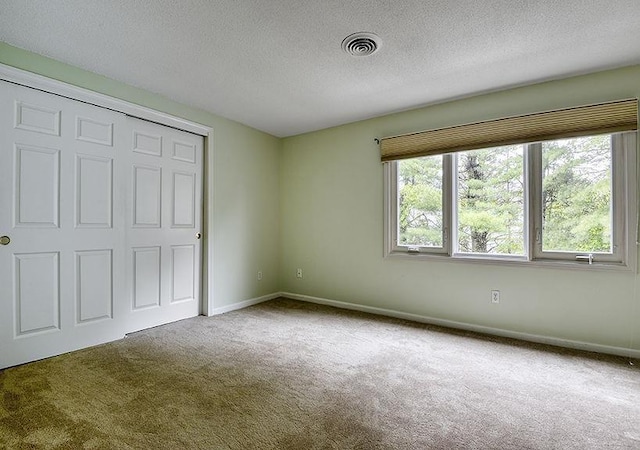 1 Wesley Ln, Keene, NH 03431 - unfurnished bedroom featuring carpet, a textured ceiling, baseboards, and a closet
