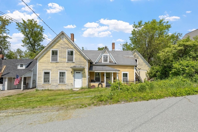 9 Laurel St, Whitefield, NH 03598 - view of front facade featuring a chimney and a porch