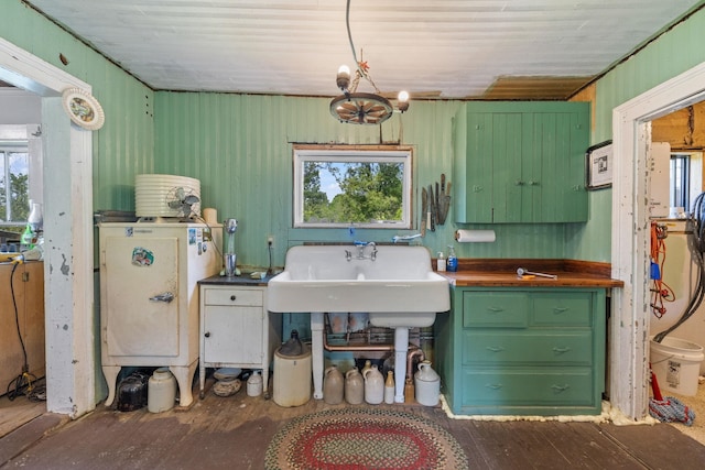 9 Laurel St, Whitefield, NH 03598 - kitchen with healthy amount of natural light, green cabinetry, wood-type flooring, wood ceiling, and a sink